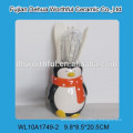 Creative ceramic utensil holder with penguin design